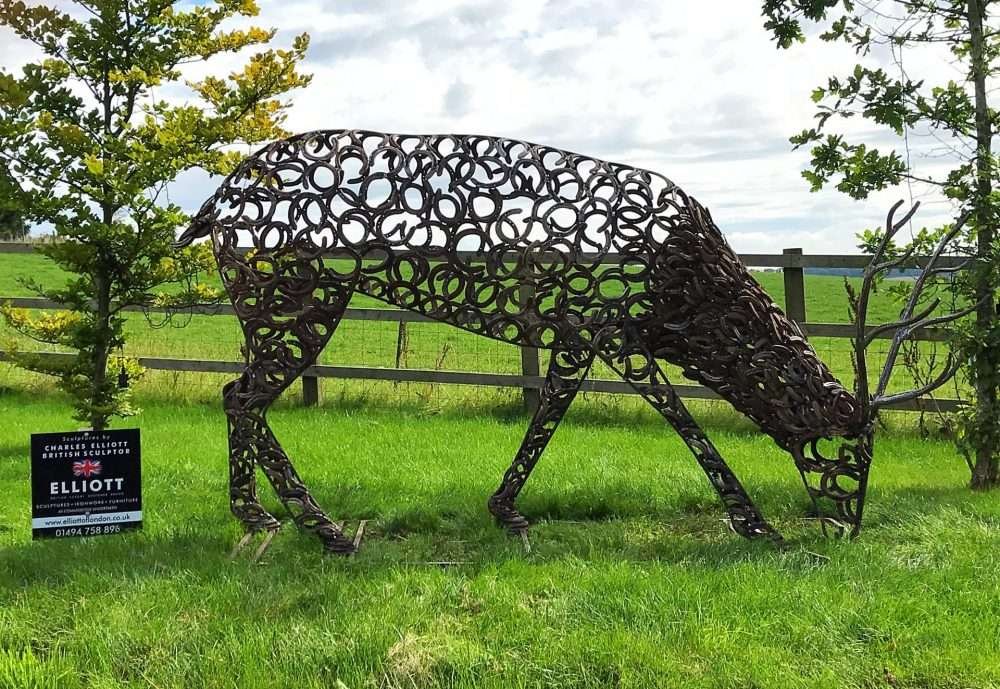 Horseshoe Stag Sculpture Grazing On Grass