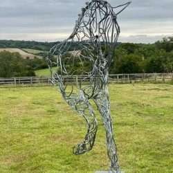 Half Horse Sculpture Standing On Black Plinth
