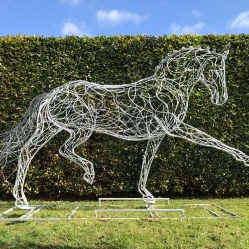 Horse Sculpture Against A Hedge