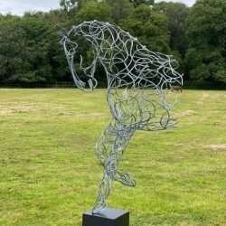 half horse design in wooded area