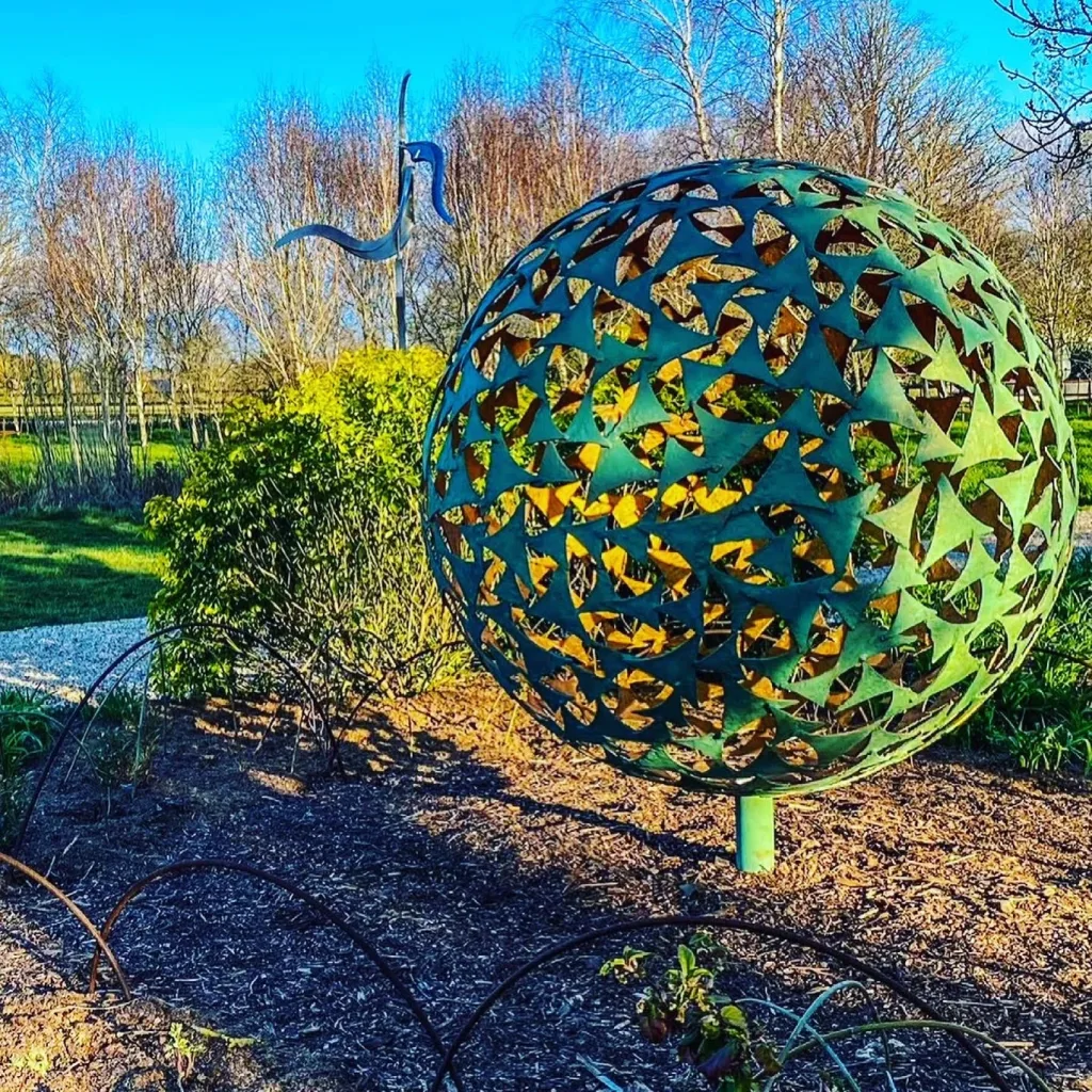 green sphere sculpture on a sunny day