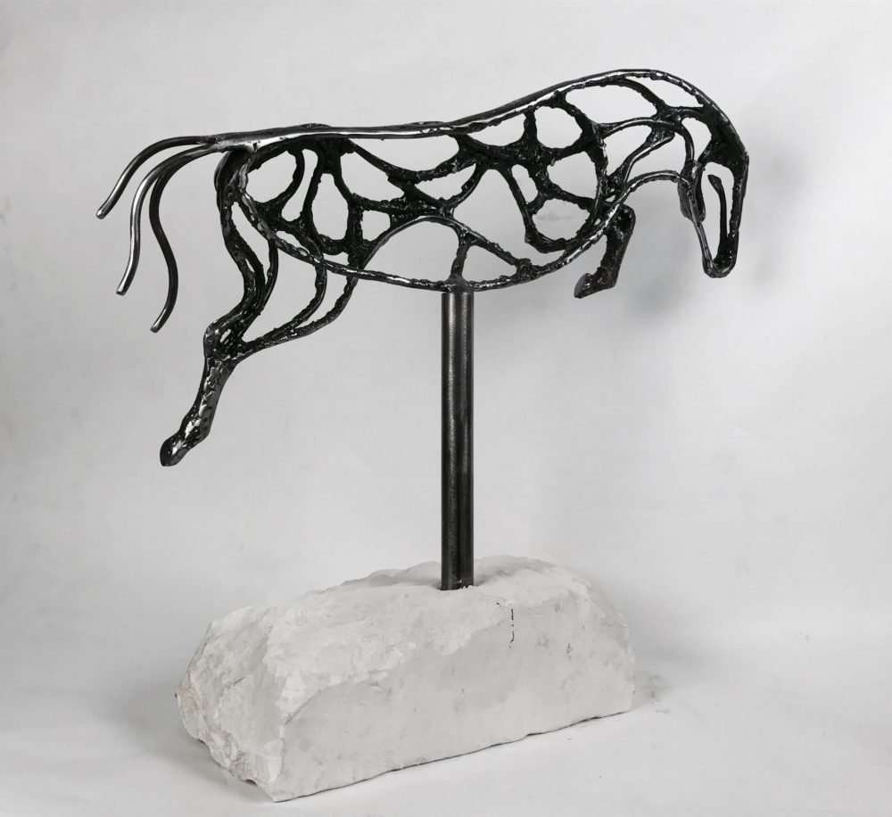 Abstract Jumping Horse Sculpture Against White Background