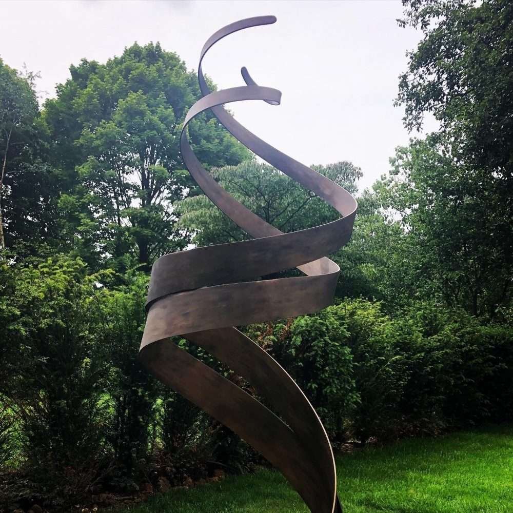 Bronze Patina Spiral Sculpture In Woodland