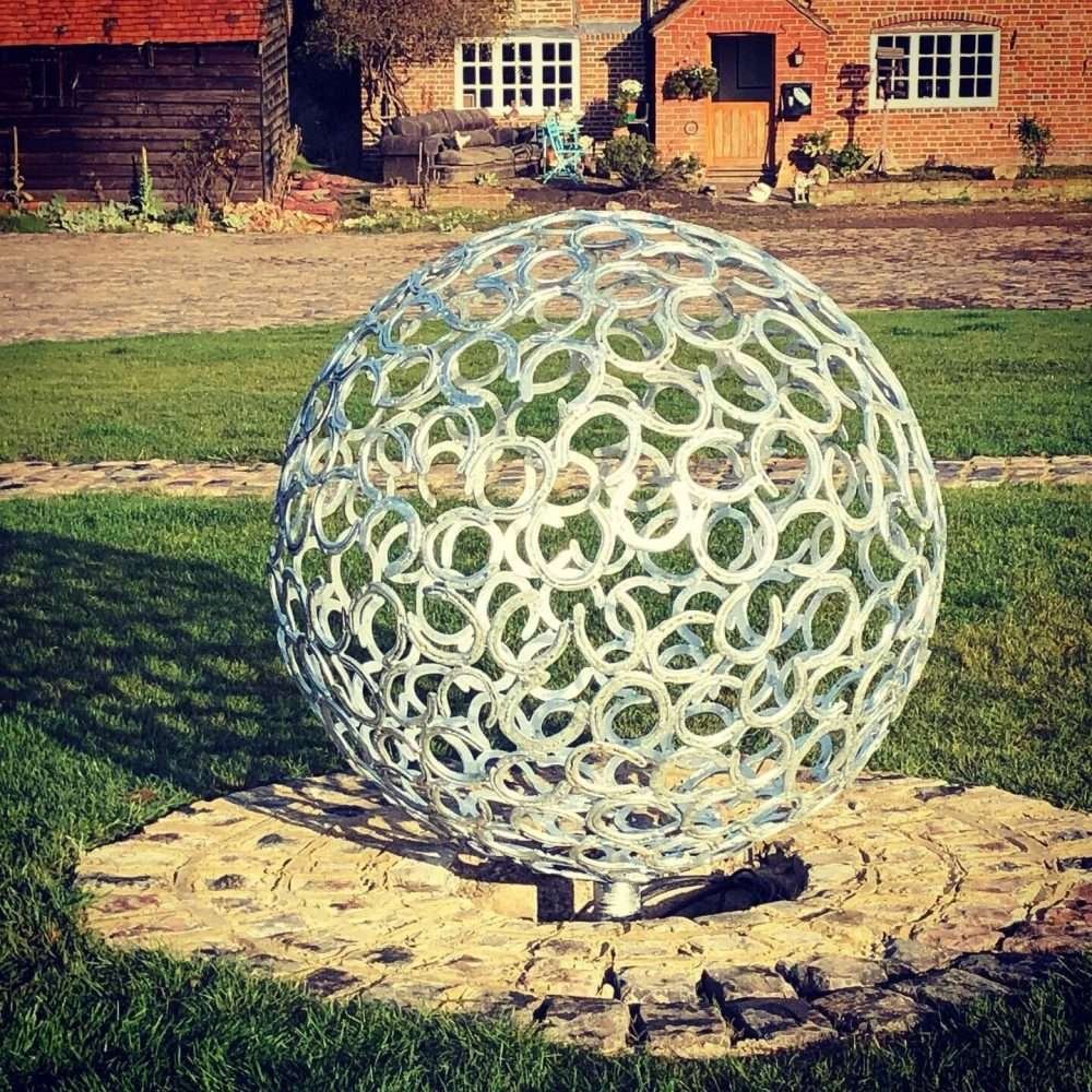 Horseshoe Sphere Sculpture At Dusk