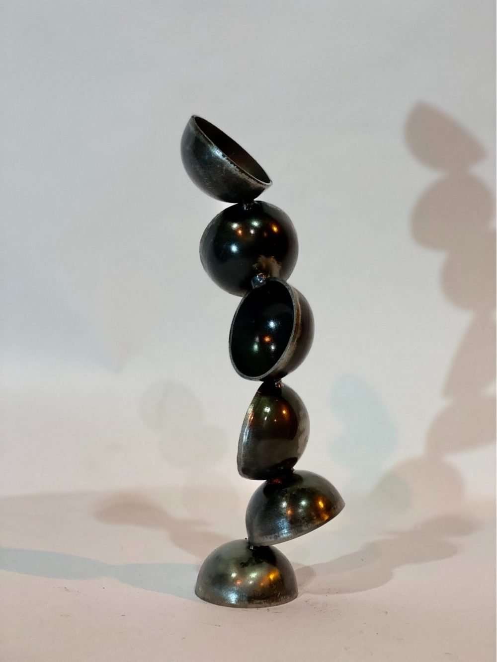 mirrored pearl sculpture on white background