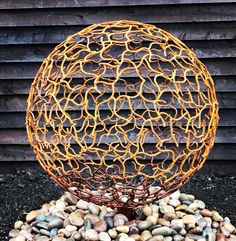 Rustic Sphere Sculpture On Rocks