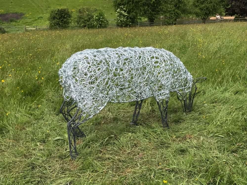 Sheep Sculpture Grazing In A Field