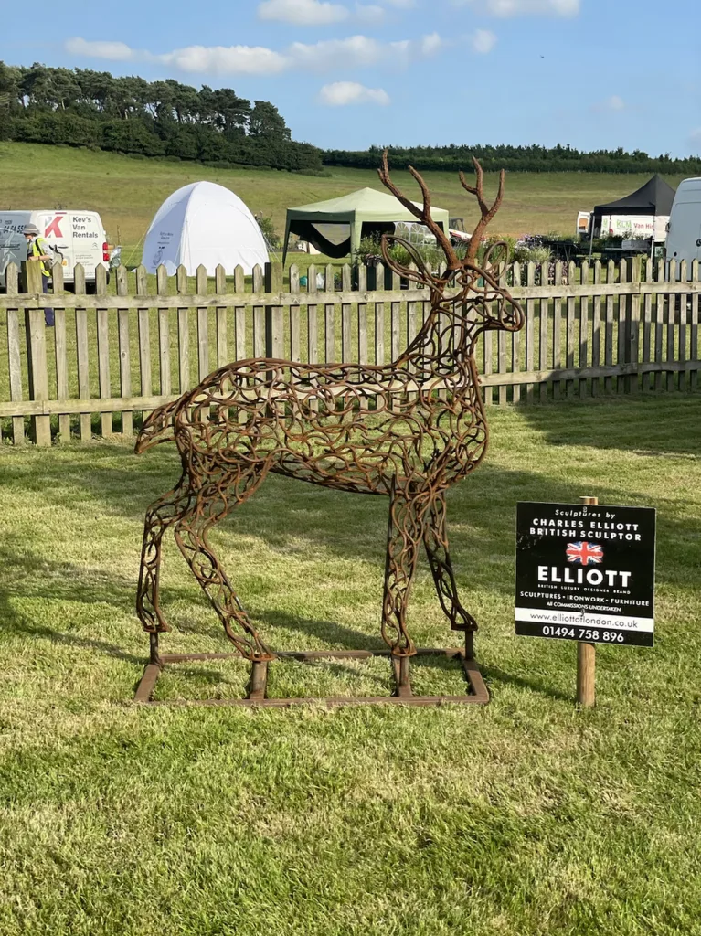 Bronze Deer Sculpture Next To Elliott Of London Sign