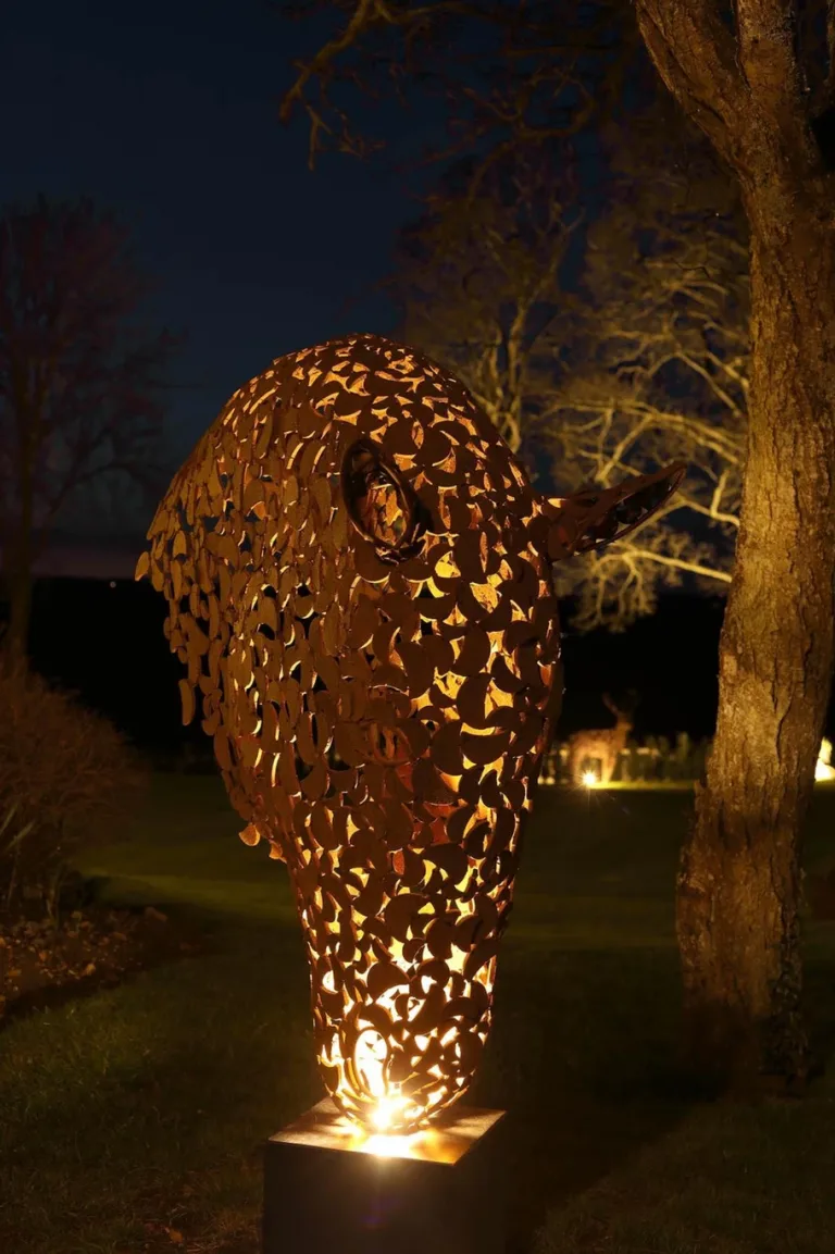 bronze horse head sculpture at night