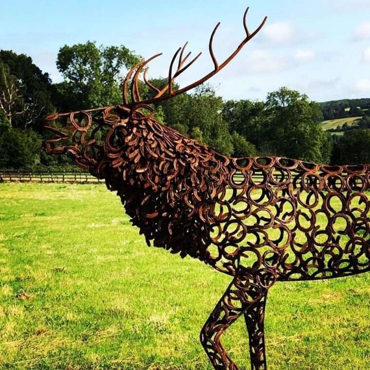 singular large stag sculpture on a sunny day