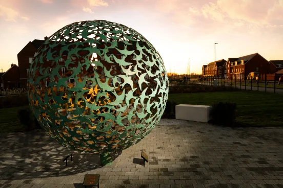 Green Bird Sphere Sculpture At Dusk