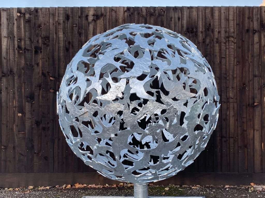 silver bird sphere sculpture