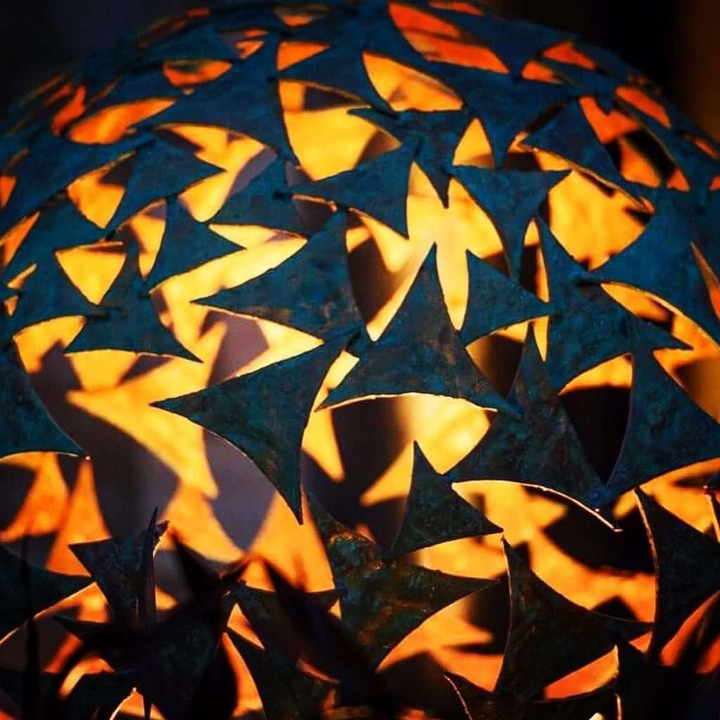 close up of a large sphere sculpture at night