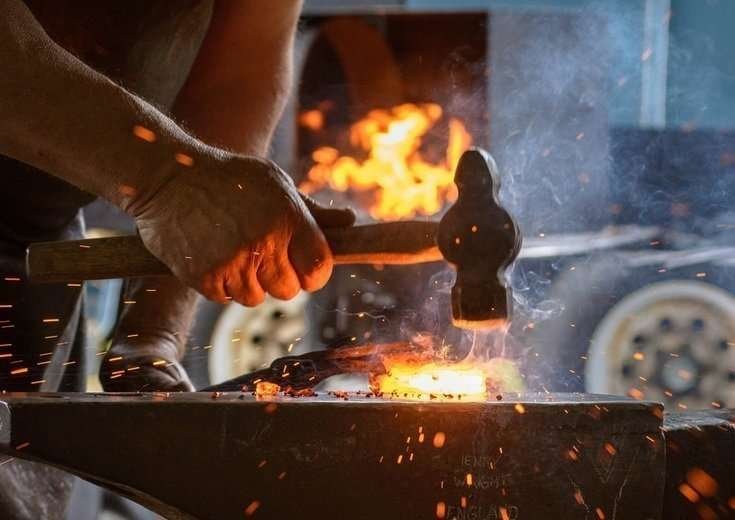 Image of a blacksmith hammering metal