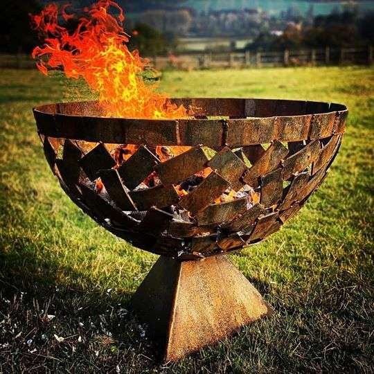 close up of medium sized fire pit in field
