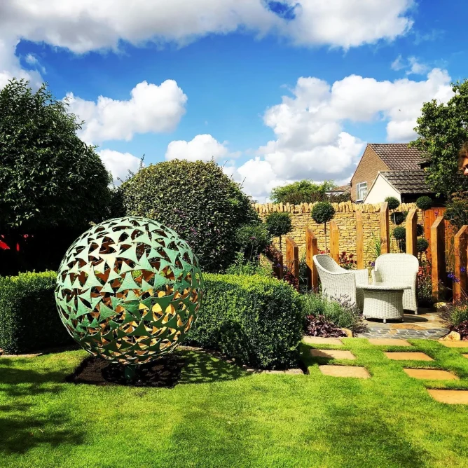 garden area with large green sphere sculpture