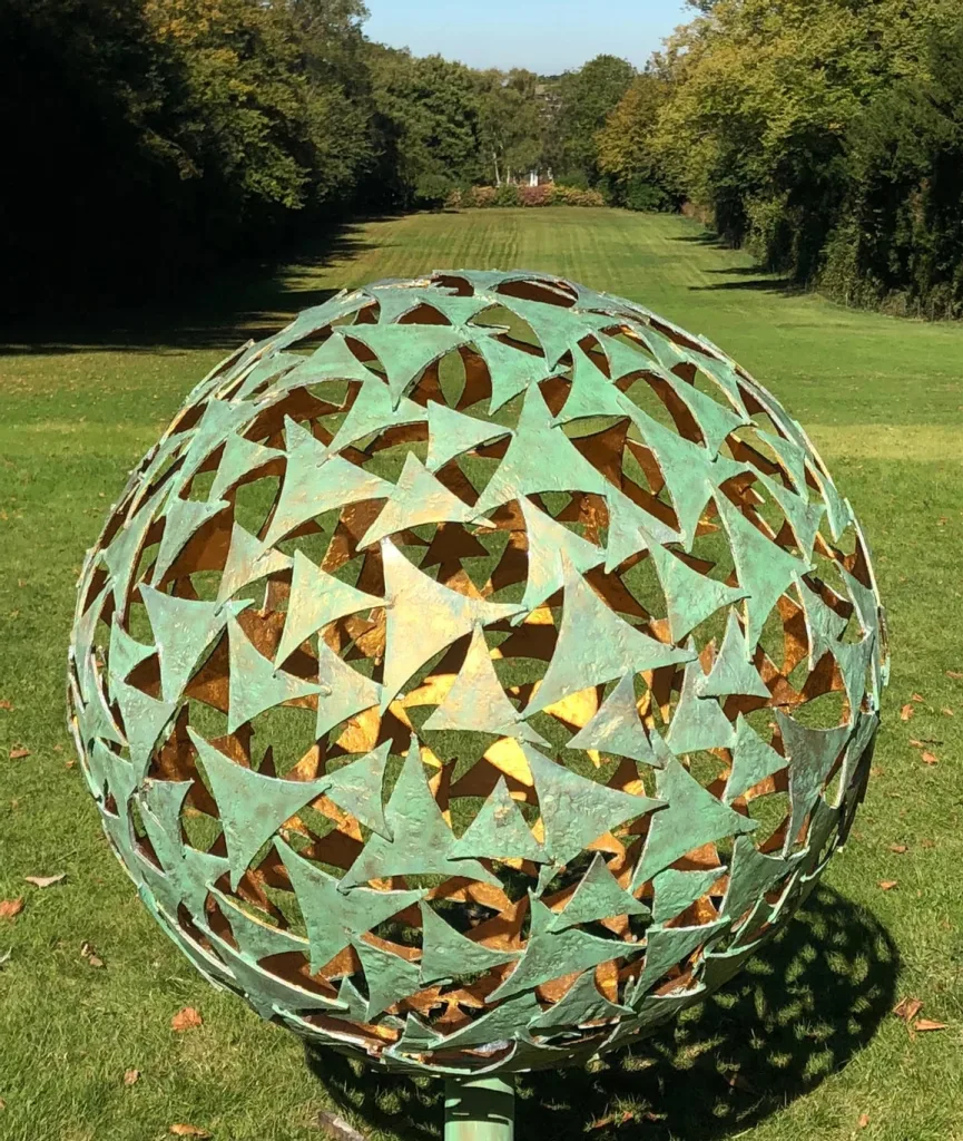long lawn with green sphere sculpture