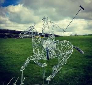 large playing polo sculpture