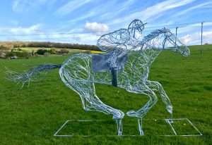 Horse and Jokey Riding Sculpture On A Sunny Day