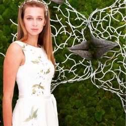 Woman In Front Of Faces Structure
