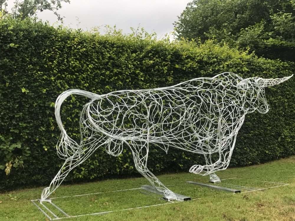 Bull Sculpture Next To Hedge
