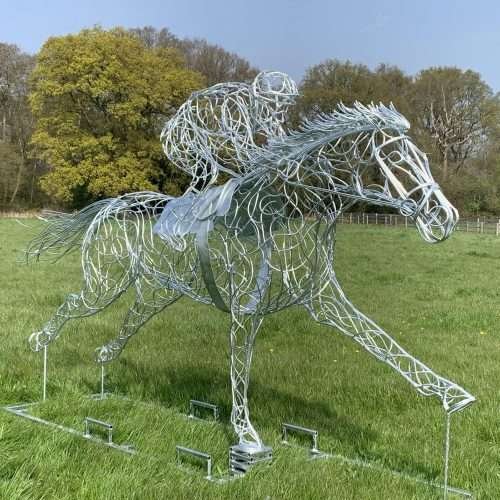 jockey and horse sculpture in field