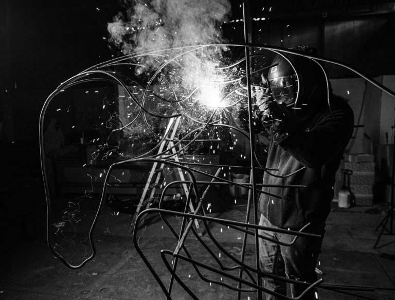 Image of Elliott welding a sculpture